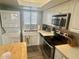Well-equipped kitchen features laundry unit, modern appliances, and plenty of cabinet storage at 6009 Sea Ranch Dr # 203, Hudson, FL 34667