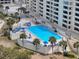 Overhead view of a sparkling pool area with lounge chairs and palm trees at 6009 Sea Ranch Dr # 203, Hudson, FL 34667