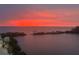 Magnificent sunset featuring vivid red hues over the tranquil water at 6009 Sea Ranch Dr # 203, Hudson, FL 34667