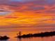 Vibrant sunset with orange skies reflecting on the calm water, capturing a serene and picturesque scene at 6009 Sea Ranch Dr # 203, Hudson, FL 34667