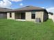 Spacious backyard with a covered patio, green grass, and privacy fencing at 1740 Chatham Green Cir, Ruskin, FL 33570