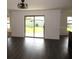 Bright living room with dark wood-look flooring and sliding glass doors leading to the backyard at 1740 Chatham Green Cir, Ruskin, FL 33570