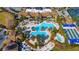 Aerial view of a large pool and patio area surrounded by palm trees and lounge chairs at 17109 Kenton Ter, Bradenton, FL 34202