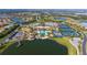 Stunning aerial view of community amenities including pool, tennis courts, clubhouse, lakes and neatly landscaped streets at 17109 Kenton Ter, Bradenton, FL 34202