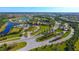 Aerial view of Del Webb community with lush green landscaping and serene lake views at 17109 Kenton Ter, Bradenton, FL 34202
