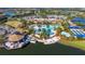 Aerial view of a community with a clubhouse, pool, lake, tennis courts and a lakefront restaurant at 17109 Kenton Ter, Bradenton, FL 34202