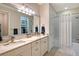 Elegant bathroom with double vanity, marble countertops, and a shower-tub combination at 17109 Kenton Ter, Bradenton, FL 34202