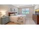 Serene bedroom with tray ceilings, ample natural light and coastal inspired décor at 17109 Kenton Ter, Bradenton, FL 34202