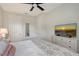 Bedroom with ceiling fan, TV and a view of the outdoors, and a dresser for storage at 17109 Kenton Ter, Bradenton, FL 34202