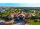 Aerial view of the community clubhouse featuring elegant architecture and beautiful landscaping at 17109 Kenton Ter, Bradenton, FL 34202
