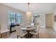 Inviting dining room with chandelier, large windows, and view of home office at 17109 Kenton Ter, Bradenton, FL 34202