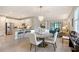 Open-concept dining area with a round table and modern chandelier, flowing into the kitchen and living room at 17109 Kenton Ter, Bradenton, FL 34202