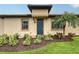 Charming home exterior with a blue front door, manicured landscaping, and a welcoming entrance at 17109 Kenton Ter, Bradenton, FL 34202
