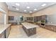 Full kitchen with stainless steel appliances and large granite-topped island at 17109 Kenton Ter, Bradenton, FL 34202