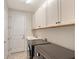 Functional laundry room with modern washer and dryer, ample storage, and sink at 17109 Kenton Ter, Bradenton, FL 34202