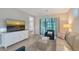 Bright living room featuring a large TV, stylish furniture, and access to the patio at 17109 Kenton Ter, Bradenton, FL 34202