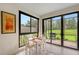 Bright sunroom with large windows, outdoor patio access, and comfortable dining at 17109 Kenton Ter, Bradenton, FL 34202