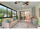 Relaxing sunroom with large windows, comfortable seating, and access to indoor living areas at 17109 Kenton Ter, Bradenton, FL 34202