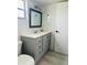 Bathroom features a vanity with storage and a classic mirror at 12215 Cobble Stone Dr, Hudson, FL 34667