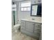 Bathroom with a sleek vanity, shower, and modern fixtures at 12215 Cobble Stone Dr, Hudson, FL 34667