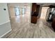 Open floorplan displaying the living room, dining area and kitchen including stainless steel appliances and a breakfast bar at 12215 Cobble Stone Dr, Hudson, FL 34667