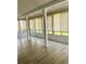 Sunroom featuring tiled floors, lots of windows, and natural lighting at 12215 Cobble Stone Dr, Hudson, FL 34667