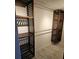 Bright walk-in closet featuring custom wood shelving with overhead lighting at 12215 Cobble Stone Dr, Hudson, FL 34667