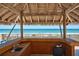 Covered outdoor bar area with beach access at 15000 Gulf Blvd # 1104, Madeira Beach, FL 33708