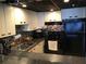 Efficient kitchen with black appliances and a modern backsplash at 15000 Gulf Blvd # 1104, Madeira Beach, FL 33708