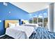 Spacious bedroom with two beds, large windows, and blue walls at 2900 Bay To Bay Blvd # 1502, Tampa, FL 33629