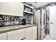 Small kitchenette with stainless steel appliances and patterned wallpaper at 2900 Bay To Bay Blvd # 1502, Tampa, FL 33629