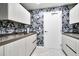 Compact kitchenette with gray countertops and black and white wallpaper at 2900 Bay To Bay Blvd # 1502, Tampa, FL 33629