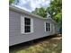 Gray manufactured home with white shutters and a spacious yard at 2459 Ayerswood Dr, Brooksville, FL 34604