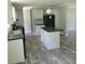 Modern kitchen with island, stainless steel appliances, and light gray cabinets at 2459 Ayerswood Dr, Brooksville, FL 34604