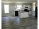 Open concept kitchen with island and gray flooring at 2459 Ayerswood Dr, Brooksville, FL 34604