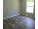 Bright bedroom with gray walls and wood-look flooring at 2459 Ayerswood Dr, Brooksville, FL 34604