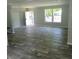 Open living room with gray flooring and lots of natural light at 2459 Ayerswood Dr, Brooksville, FL 34604