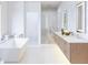 Spa-like bathroom with double vanity, soaking tub, and glass shower at 85 Davis Blvd # B, Tampa, FL 33606