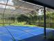 Screened in pool with blue cover at 1404 Midoneck Ct, Valrico, FL 33596