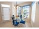 Breakfast nook with glass table and blue chairs at 320 Ibisview Lane # 33572, Apollo Beach, FL 33572