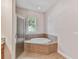 Bathroom with corner bathtub and shower at 320 Ibisview Lane # 33572, Apollo Beach, FL 33572