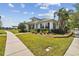 House exterior showcasing a metal roof, landscaping, and walkway at 320 Ibisview Lane # 33572, Apollo Beach, FL 33572
