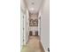 Long hallway with carpet and decorative wall art at 320 Ibisview Lane # 33572, Apollo Beach, FL 33572