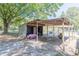 Rustic storage shed with covered parking area for vehicles and equipment at 3736 Lado Dr, Wesley Chapel, FL 33543
