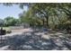 Large backyard with above ground pool, playground, and mature trees at 3736 Lado Dr, Wesley Chapel, FL 33543