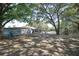 Large backyard with shed, home partially visible, mature trees at 3736 Lado Dr, Wesley Chapel, FL 33543