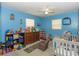 Colorful bedroom with a crib and toy storage at 3736 Lado Dr, Wesley Chapel, FL 33543
