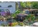 Rustic pond feature with old vehicle art, lush landscaping, and seating at 3736 Lado Dr, Wesley Chapel, FL 33543