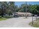 Ranch home on a spacious lot with a gravel driveway at 3736 Lado Dr, Wesley Chapel, FL 33543