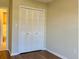 Bedroom featuring laminate wood flooring, closet, and natural light at 4329 Tahitian Gardens Cir # B, Holiday, FL 34691